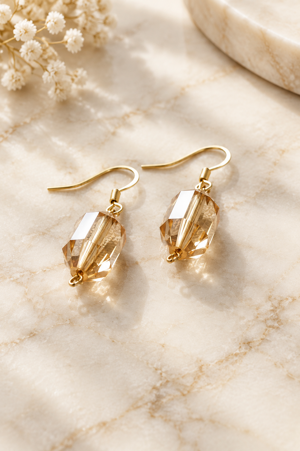Golden Noir Earrings on cream marble