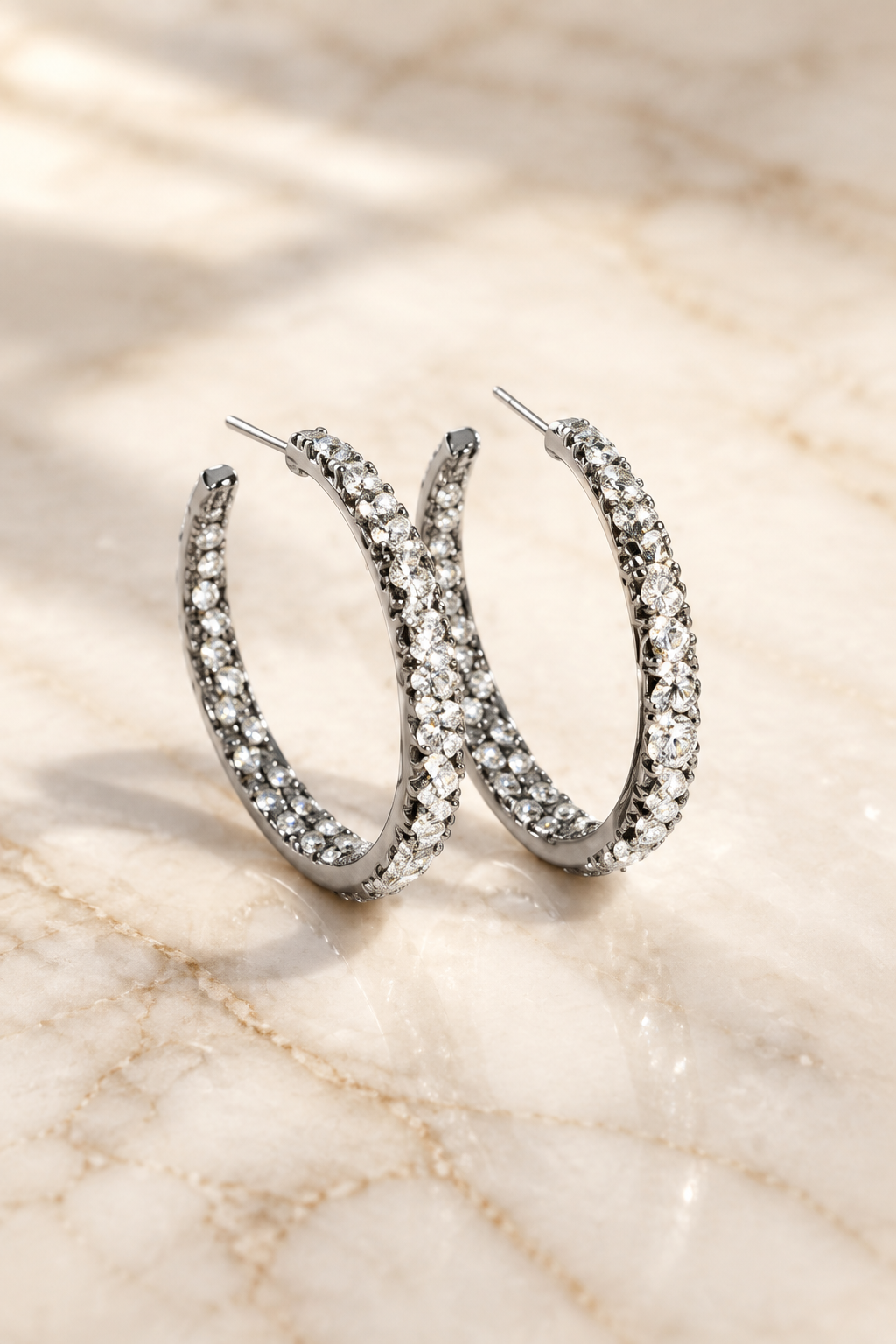 Silver Rhinestone Hoop Earrings on cream marble