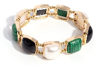 Gold bracelet with green and black stones on a white background