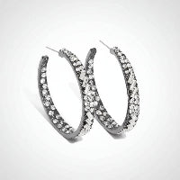 Pair of silver hoop earrings with clear gemstones on a white background