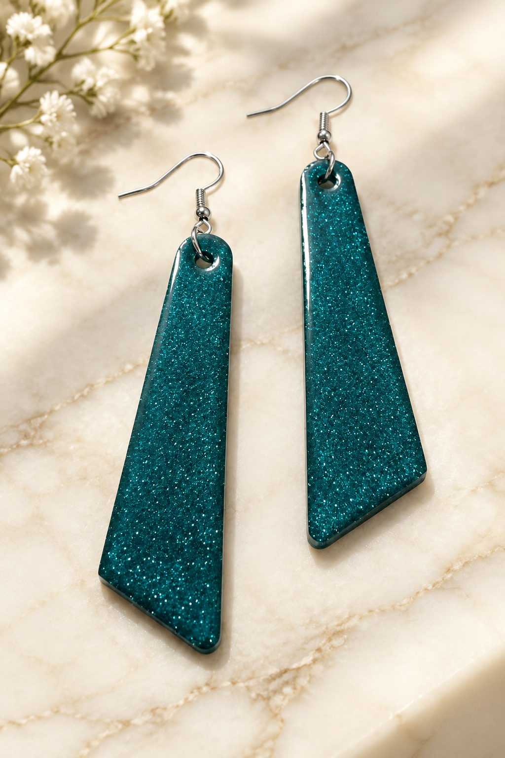 Emerald Luxe Resin Geometric Drop Earrings on cream marble