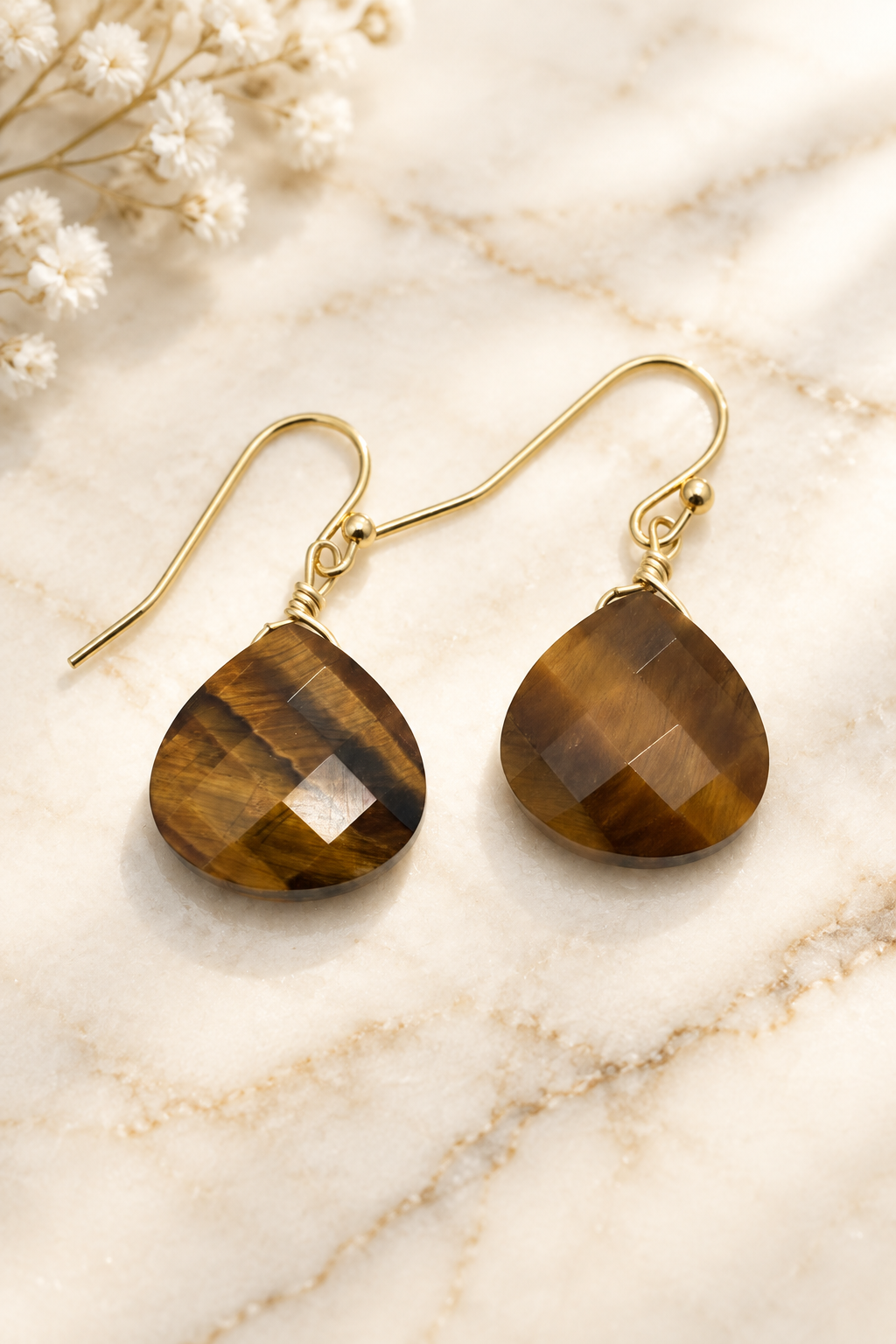 Faceted Tiger Eye Gemstone Drop Earrings on cream marble