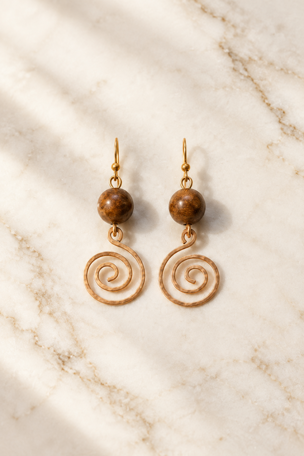 Tiger Eye Heritage Spiral Earrings on cream marble