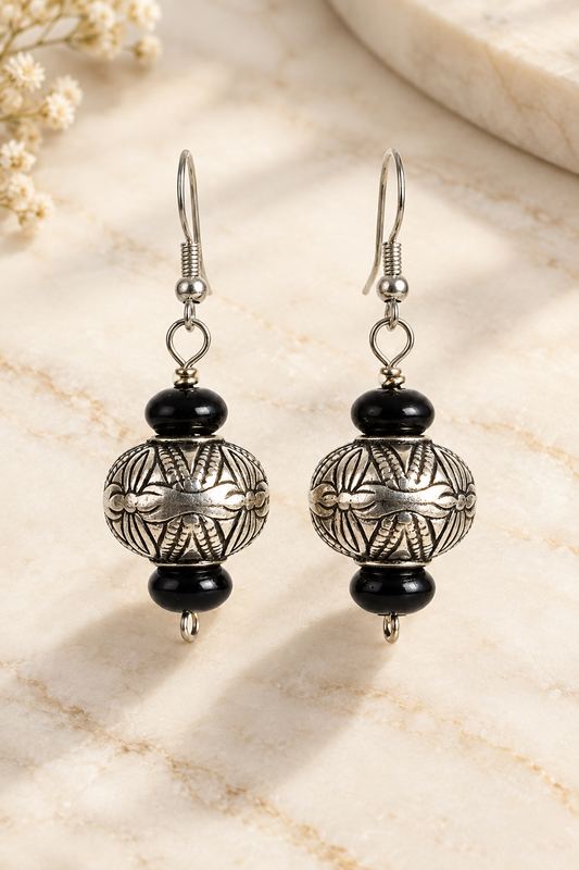 Tribal Silver Statement Earrings on cream marble